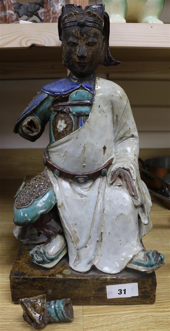A Chinese Shiwan pottery seated figure of a deity 48cm. (a.f)